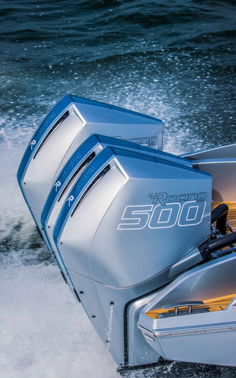 Slide: The Image of Triple outboard engines on a 2026 Nor-Tech 420 Monte Carlo boat in action. - 6