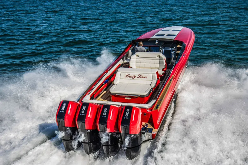 The Image of 2026 Nor-Tech 550 & 560 Sport Center Console boat speeding on water, rear view. - 0