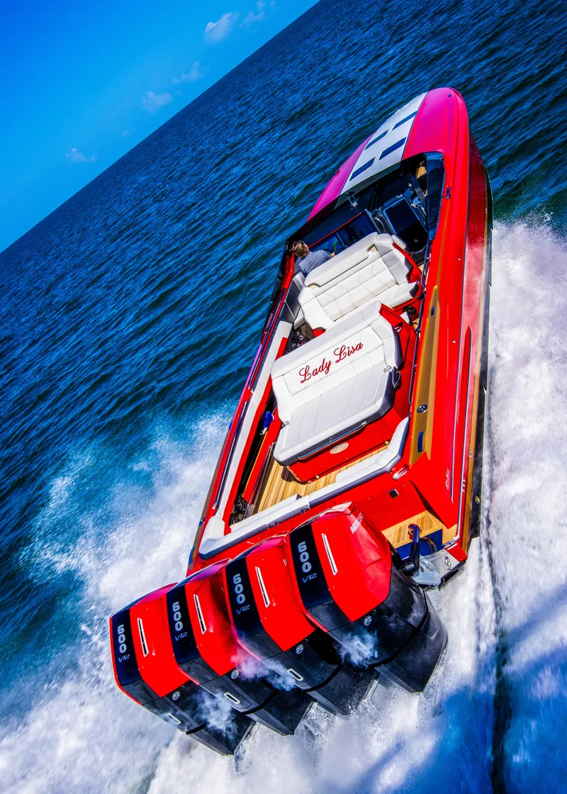 Slide: The Image of Red 2026 Nor-Tech 550 & 560 Sport Center Console boat speeding on open water. - 10