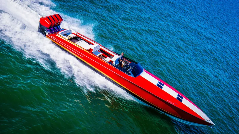 Slide: The Image of 2026 Nor-Tech 550 & 560 Sport Center Console speeding on open water, vibrant red design. - 12