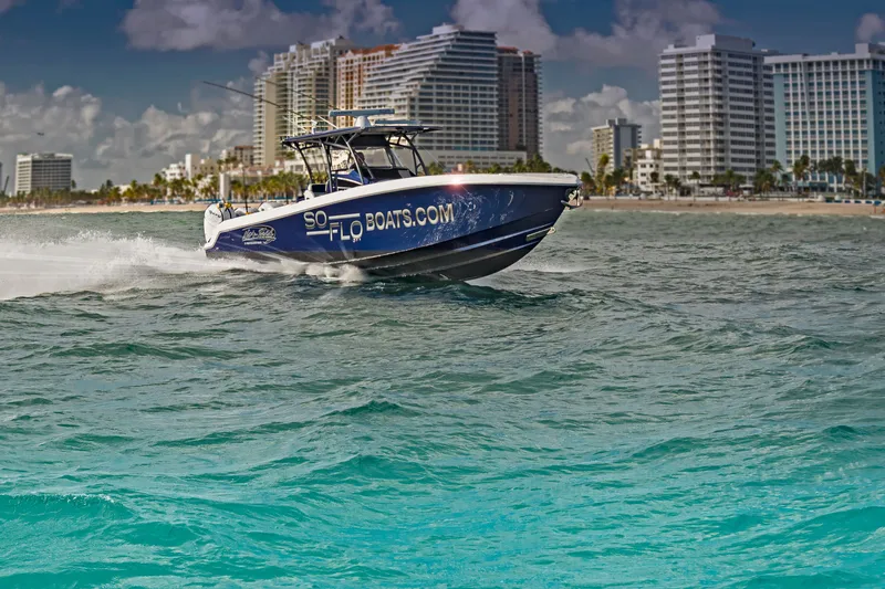 The Image of 2026 Nor-Tech 392 Super Fish boat cruising near city skyline. - 0