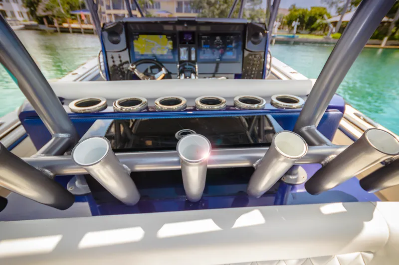 Slide: The Image of 2026 Nor-Tech 392 Super Fish boat dashboard with rod holders and navigation system. - 5