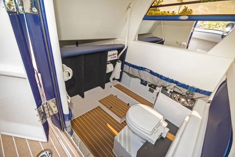 Slide: The Image of 2026 Nor-Tech 392 Super Fish interior cabin with toilet and sink, featuring modern amenities. - 8