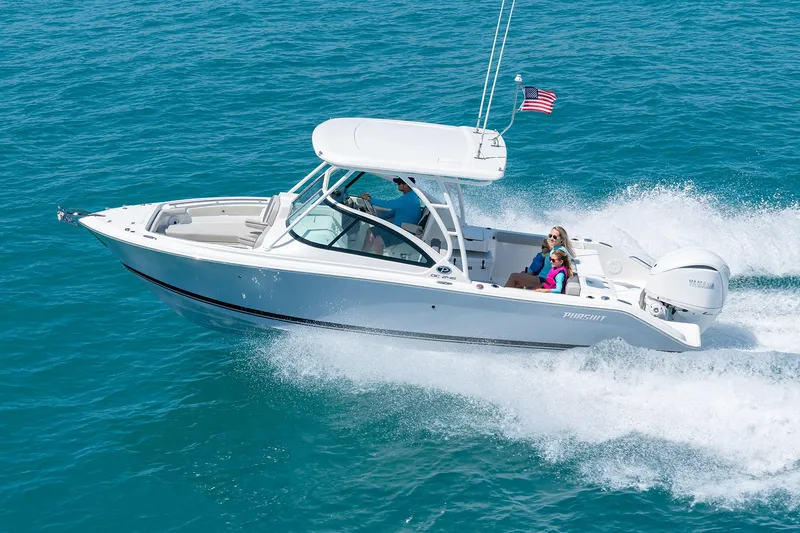Slide: The Image of 2025 Pursuit DC 246 boat cruising on clear blue water. - 2