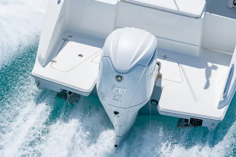 Slide: The Image of 2025 Pursuit DC 246 boat with powerful outboard motor on water. - 3