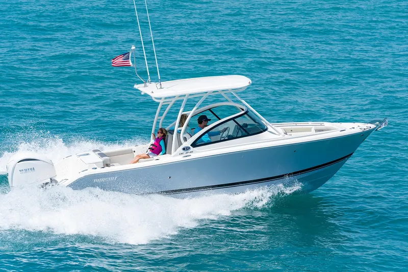 Slide: The Image of 2025 Pursuit DC 246 boat cruising on open water. - 6