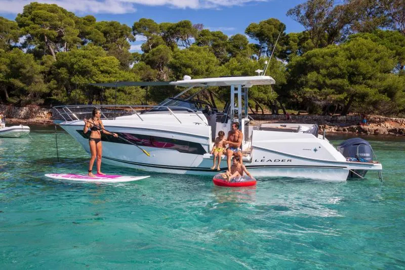 Slide: The Image of 2024 Jeanneau Leader 10.5 WA S2 boat with family enjoying water activities. - 8