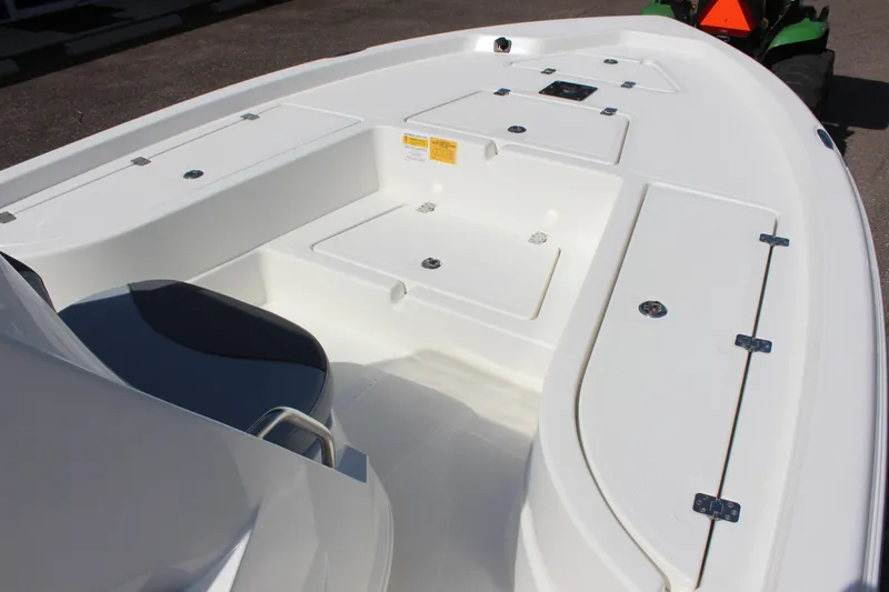 Slide: The Image of 2023 NauticStar 215 XTS boat interior with storage compartments and seating. - 10