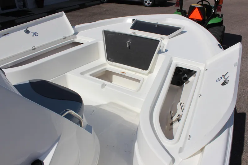 Slide: The Image of 2023 NauticStar 215 XTS boat interior with open storage compartments. - 11