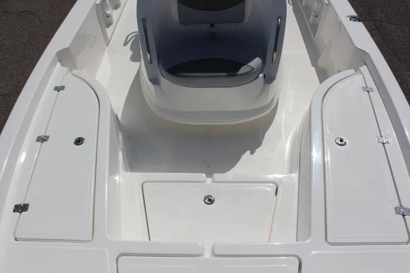 Slide: The Image of 2023 NauticStar 215 XTS boat interior with storage compartments and seating. - 12