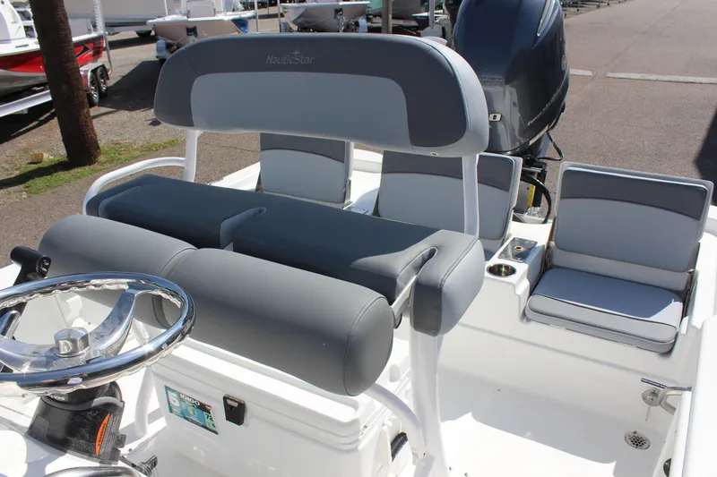 Slide: The Image of 2023 NauticStar 215 XTS boat interior with gray seating and steering wheel. - 15