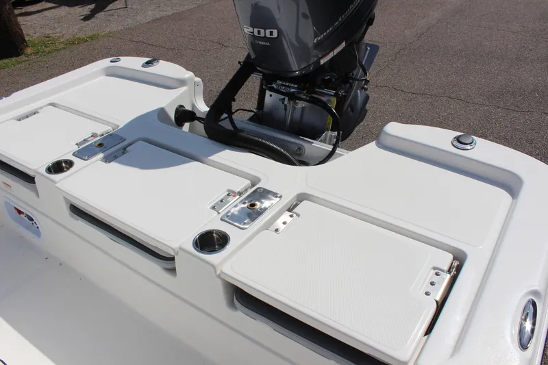 Slide: The Image of 2023 NauticStar 215 XTS boat with Yamaha 200 engine, featuring rear deck storage. - 17