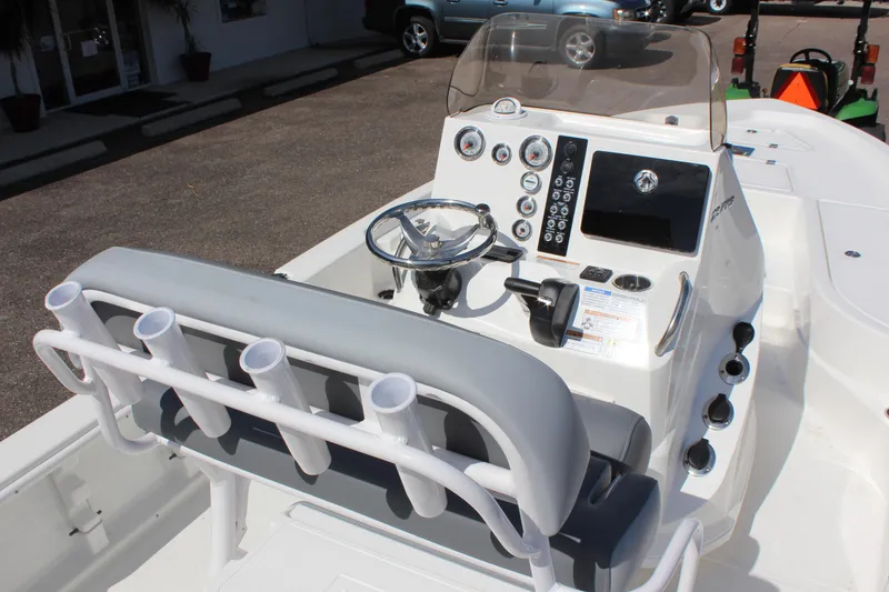 Slide: The Image of 2023 NauticStar 215 XTS boat console with steering wheel and rod holders. - 19