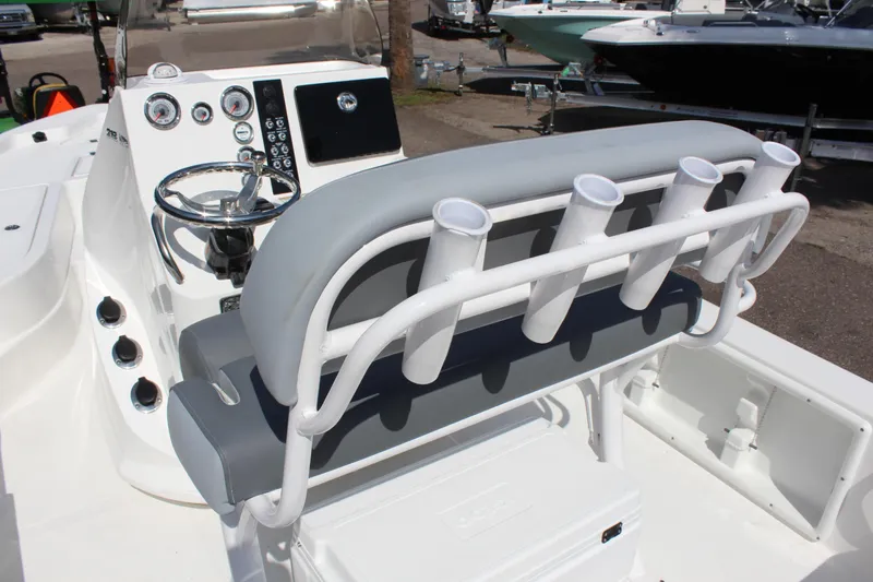 Slide: The Image of 2023 NauticStar 215 XTS boat interior with steering console and rod holders. - 21