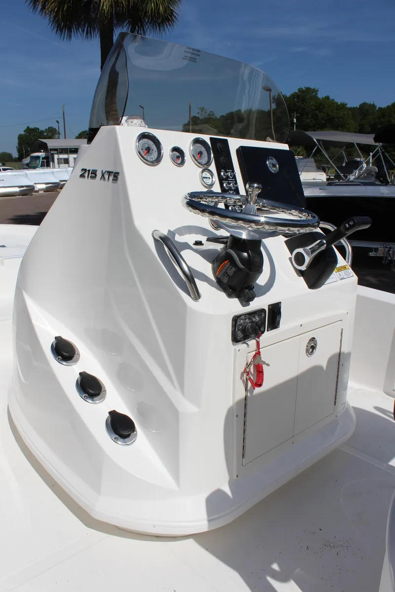 Slide: The Image of 2023 NauticStar 215 XTS boat console with steering wheel and controls. - 22