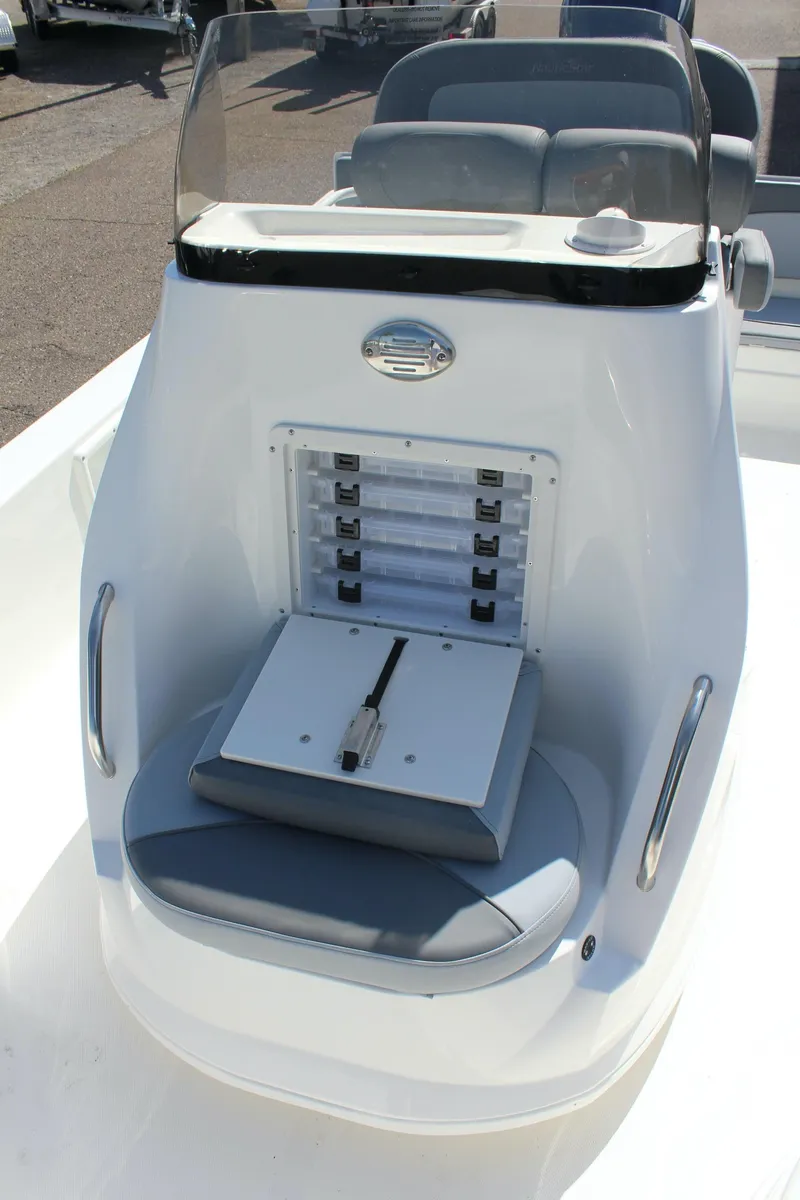 Slide: The Image of 2023 NauticStar 215 XTS boat console with seating and storage compartment. - 23