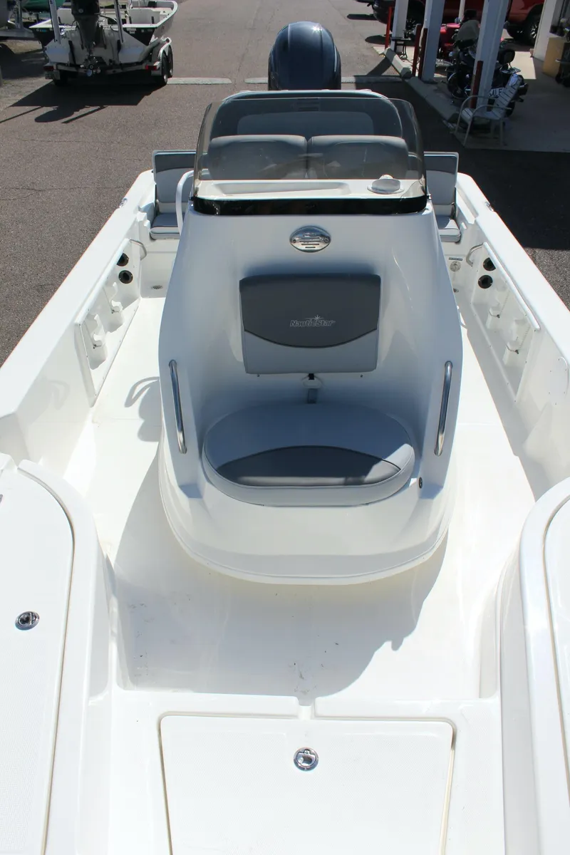 Slide: The Image of 2023 NauticStar 215 XTS boat interior with seating and console. - 24