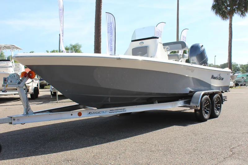 Slide: The Image of 2023 NauticStar 215 XTS boat on trailer, parked outdoors. - 3