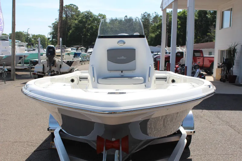 Slide: The Image of 2023 NauticStar 215 XTS boat on trailer, displayed outdoors at a dealership. - 4