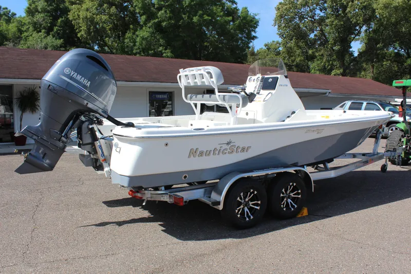 Slide: The Image of 2023 NauticStar 215 XTS boat with Yamaha outboard motor on trailer. - 7