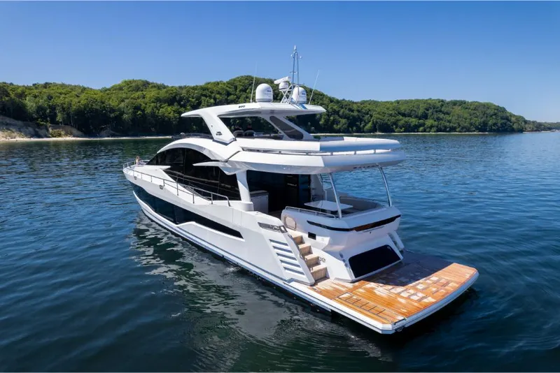 Slide: The Image of 2023 Galeon 800 Fly luxury yacht on serene water. - 10