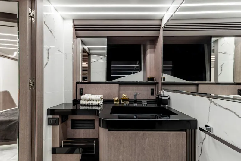 Slide: The Image of Modern bathroom in 2023 Galeon 800 Fly yacht with sleek black sink and marble accents. - 32