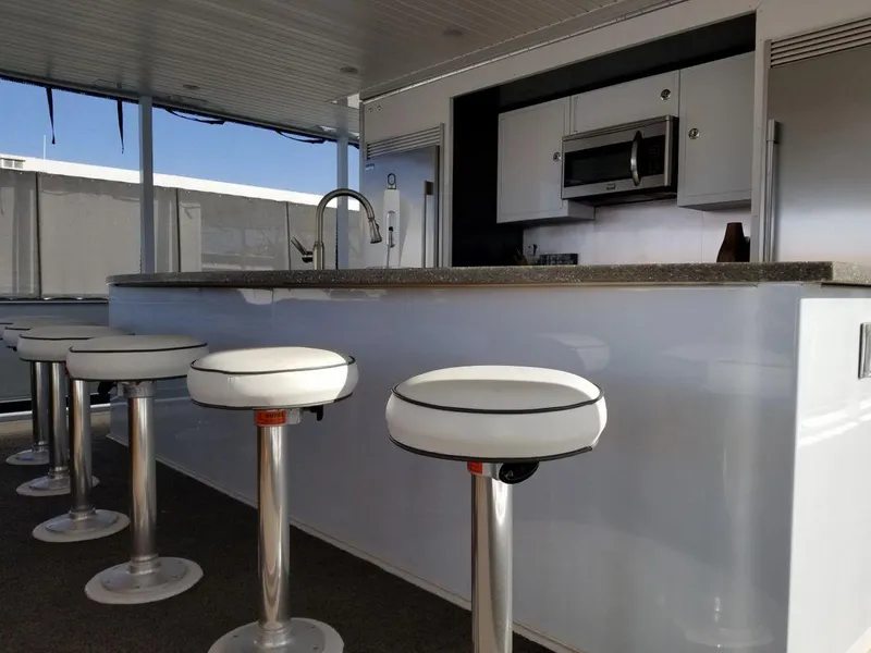 Slide: The Image of Modern kitchen area on 2016 Bravada Epic Journey houseboat with bar stools and appliances. - 11