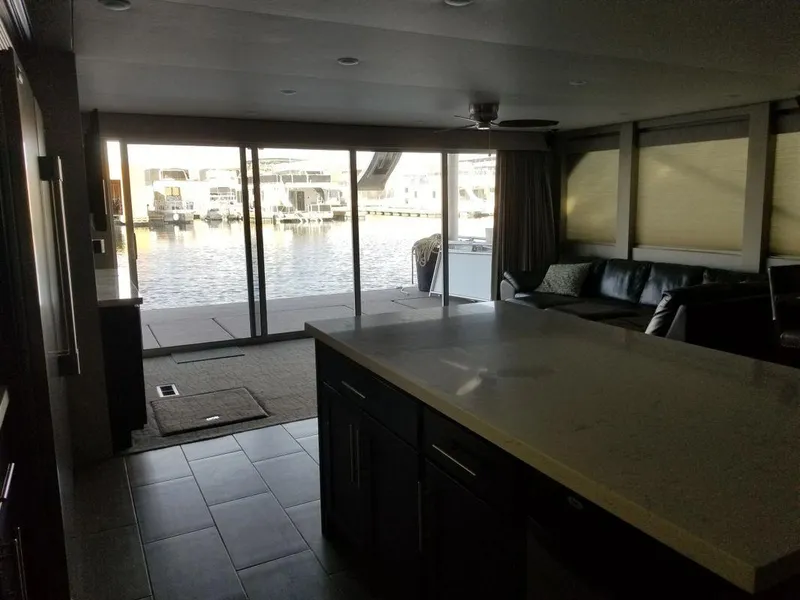 Slide: The Image of Interior of 2016 Bravada Epic Journey houseboat with waterfront view and modern furnishings. - 9