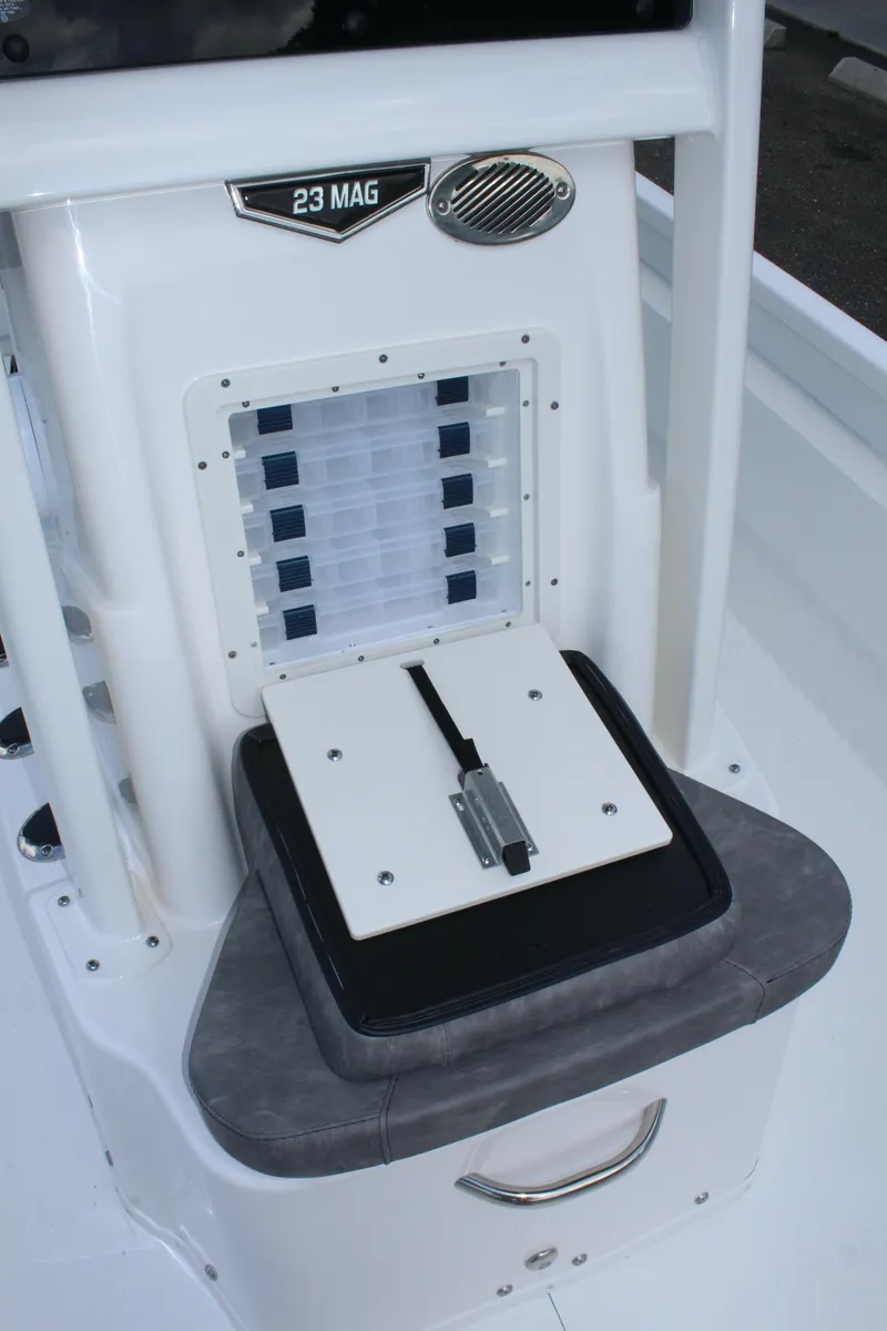 Slide: The Image of Avid AVID 23 MAG 2023 boat console with storage compartments and cushioned seat. - 12