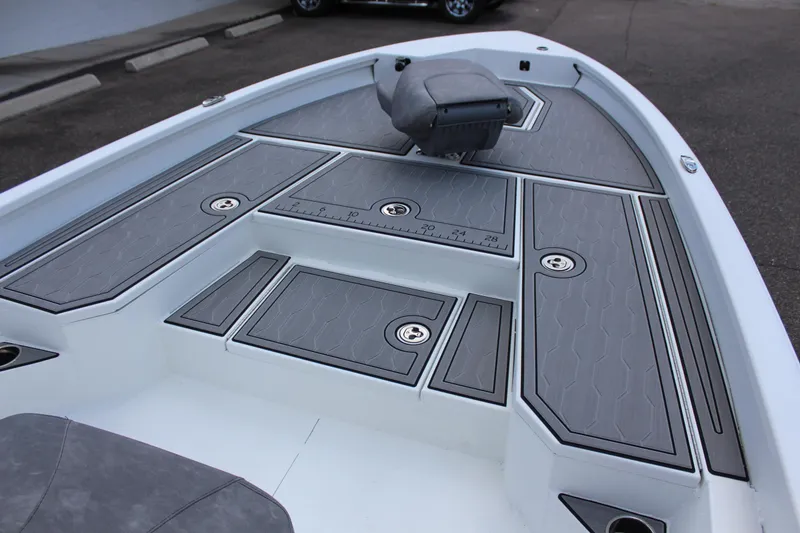 Slide: The Image of 2023 Avid AVID 23 MAG boat deck with gray cushioned seating and storage compartments. - 13