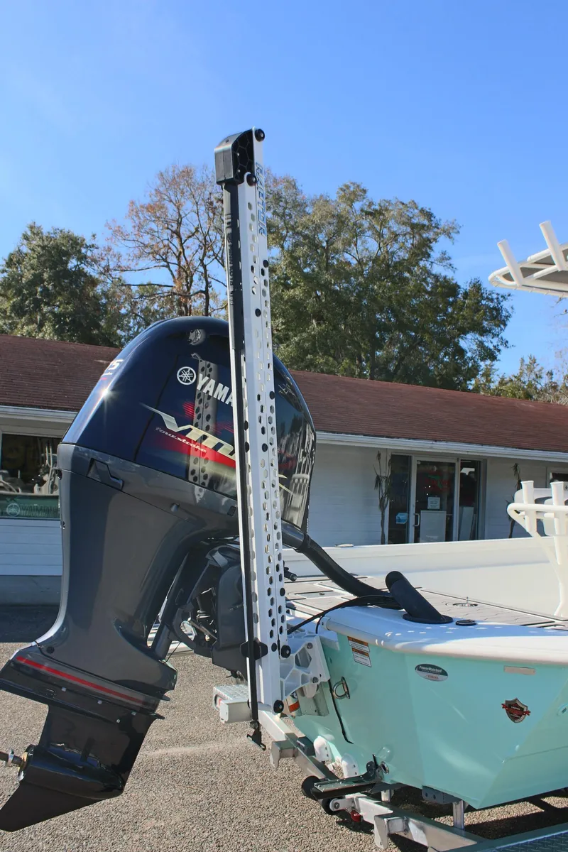 Slide: The Image of 2023 Avid AVID 23 MAG boat with Yamaha outboard motor, parked outdoors. - 18