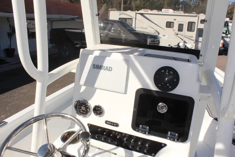 Slide: The Image of 2023 Avid AVID 23 MAG boat dashboard with Simrad display and steering wheel. - 20