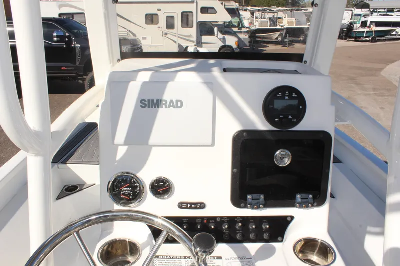 Slide: The Image of 2023 Avid AVID 23 MAG boat dashboard with Simrad display and controls. - 21