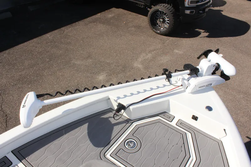 Slide: The Image of Avid 23 MAG 2023 boat with trolling motor on deck, parked on pavement. - 22