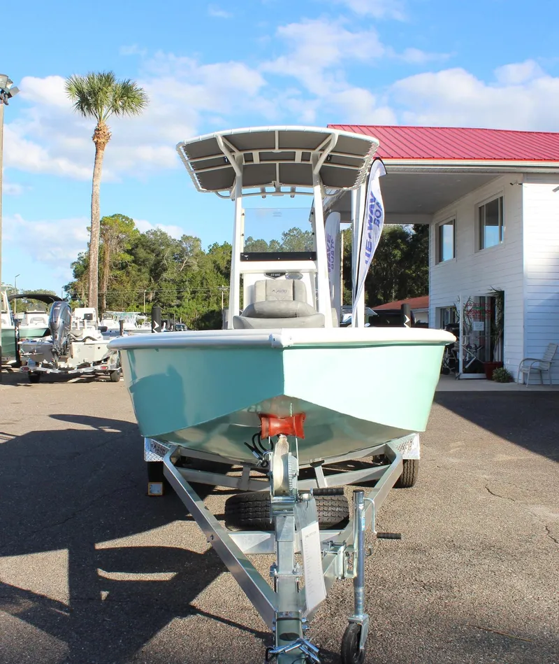 Slide: The Image of 2023 Avid AVID 23 MAG boat on trailer in dealership lot. - 6