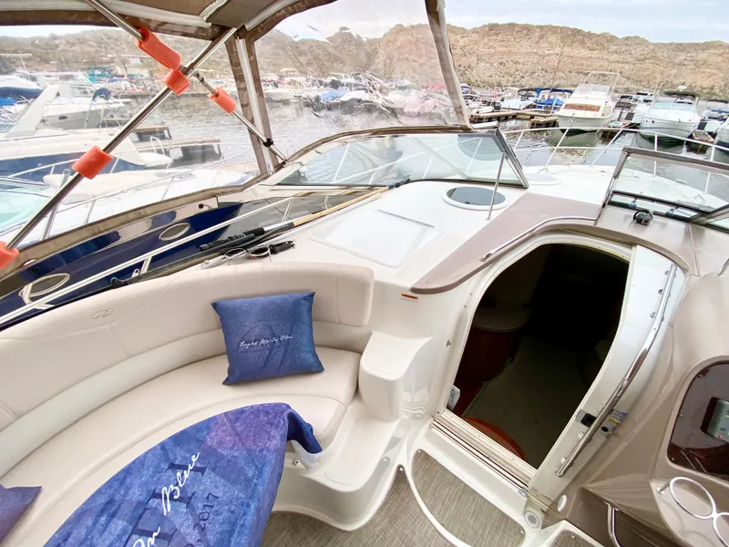 Slide: The Image of 2002 Regal 3860 Commodore yacht interior with seating and marina view. - 11