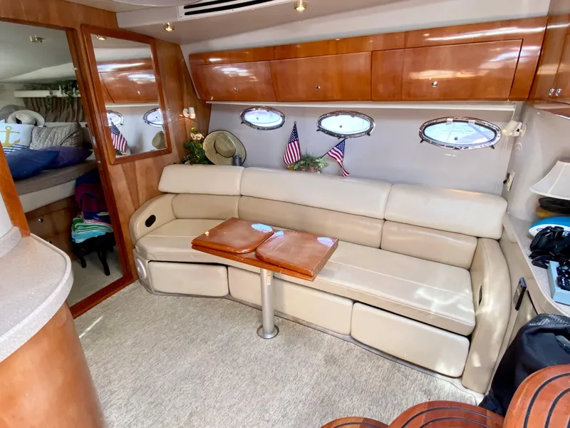 Slide: The Image of 2002 Regal 3860 Commodore yacht interior with leather seating and wooden accents. - 18