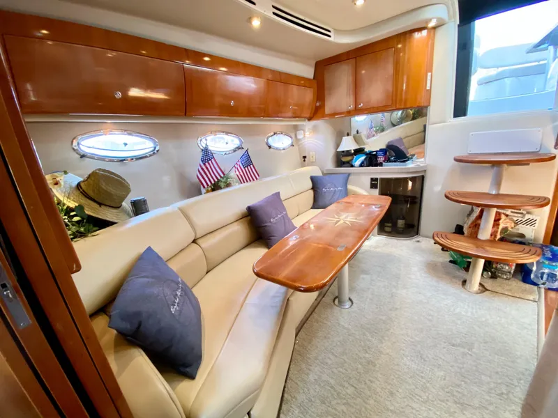 Slide: The Image of Interior of 2002 Regal 3860 Commodore yacht with plush seating and wooden accents. - 19