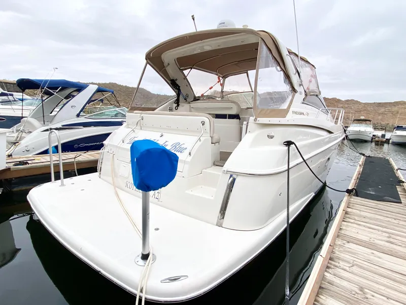 Slide: The Image of 2002 Regal 3860 Commodore yacht docked at marina, rear view. - 2