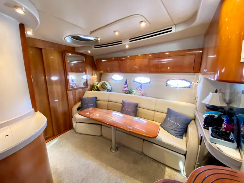 Slide: The Image of Luxurious interior of 2002 Regal 3860 Commodore yacht with plush seating and elegant wood finishes. - 22