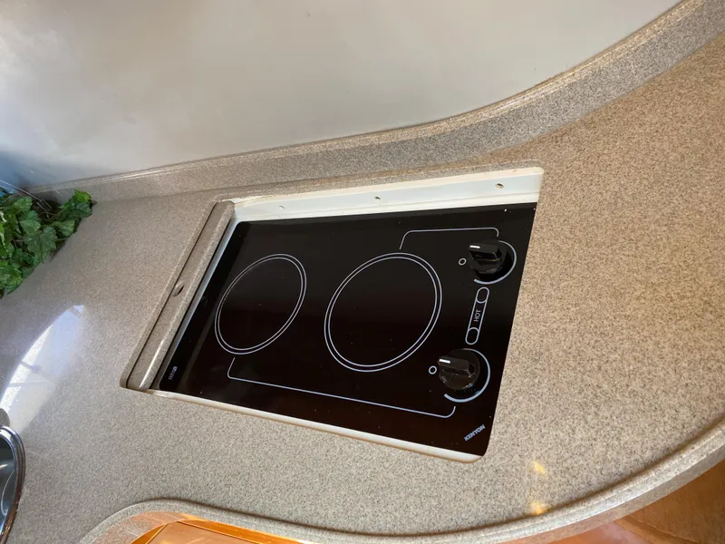 Slide: The Image of 2002 Regal 3860 Commodore kitchen with built-in electric stovetop. - 25