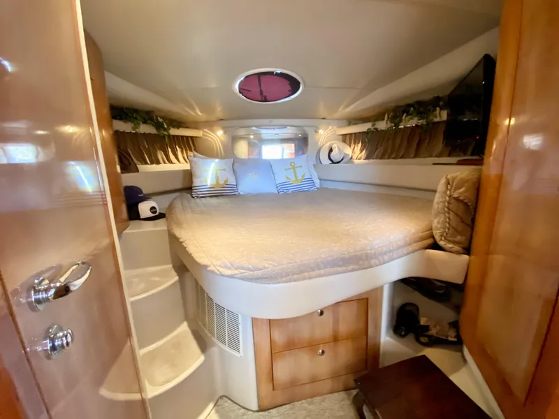 Slide: The Image of Interior of 2002 Regal 3860 Commodore yacht with cozy bedroom and nautical decor. - 26