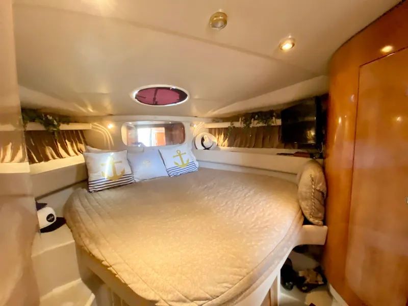 Slide: The Image of Interior cabin of 2002 Regal 3860 Commodore yacht with cozy bed and nautical decor. - 27