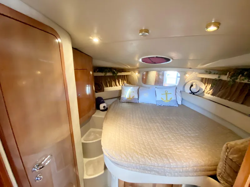 Slide: The Image of 2002 Regal 3860 Commodore cabin interior with cozy bed and nautical decor. - 28