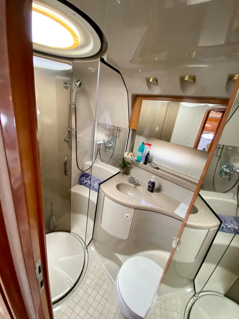 Slide: The Image of 2002 Regal 3860 Commodore yacht bathroom with shower, sink, and mirror. - 29