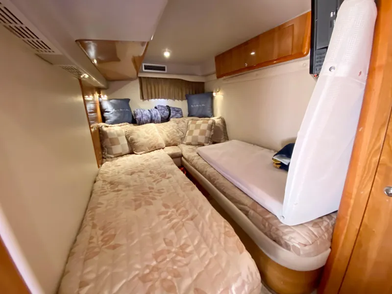 Slide: The Image of 2002 Regal 3860 Commodore cabin interior with cozy bedding and cushions. - 31