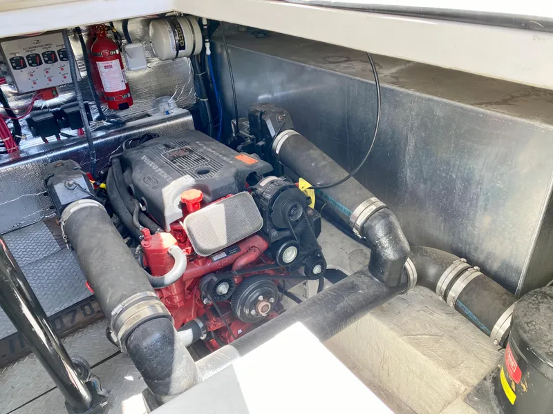 Slide: The Image of Engine compartment of 2002 Regal 3860 Commodore boat, featuring visible components and fire extinguisher. - 36