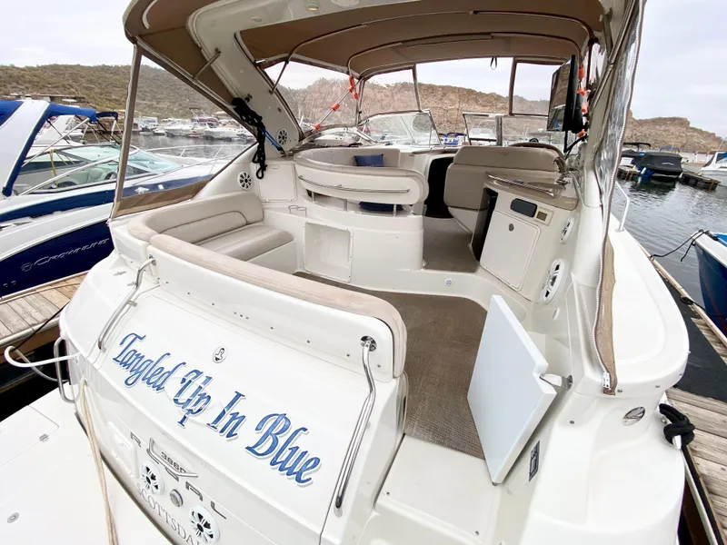 Slide: The Image of 2002 Regal 3860 Commodore yacht docked, featuring spacious seating and elegant design. - 4