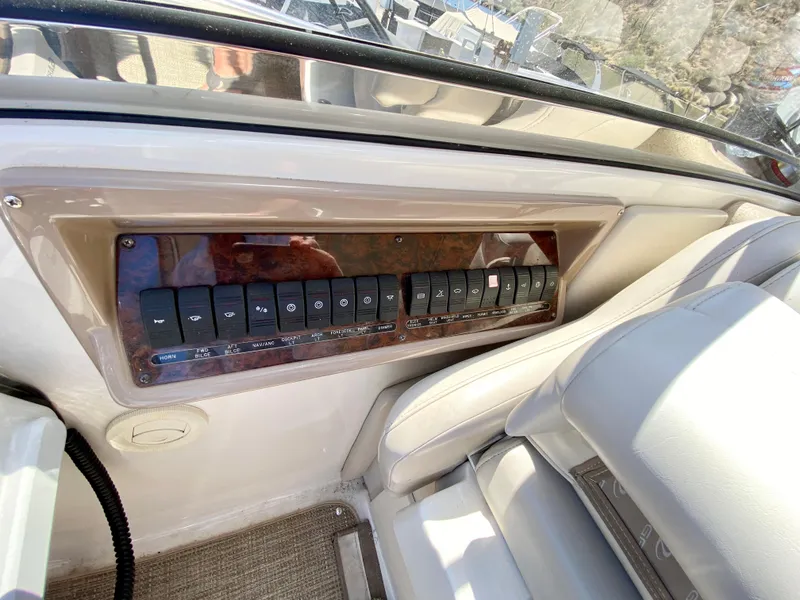 Slide: The Image of Control panel of 2002 Regal 3860 Commodore boat with multiple switches. - 7