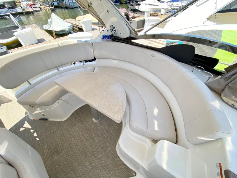 Slide: The Image of 2002 Regal 3860 Commodore boat with curved seating and table on deck. - 9